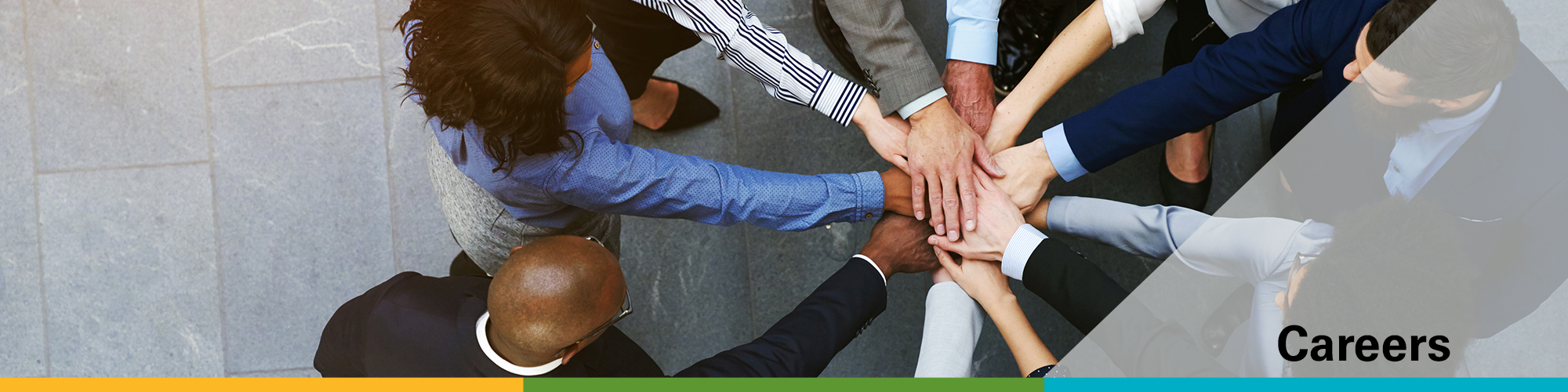 a group of people in suits standing in a circle with their hands in the middle