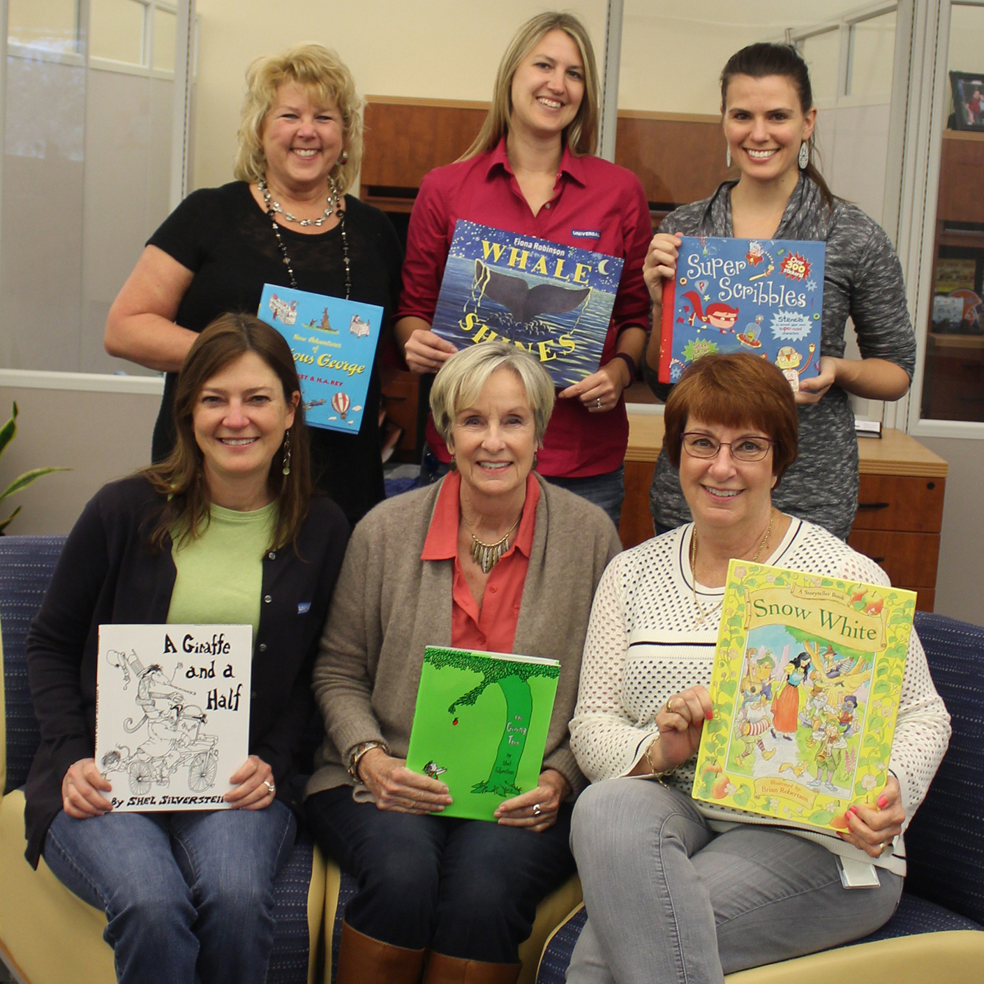 women holding childrens books